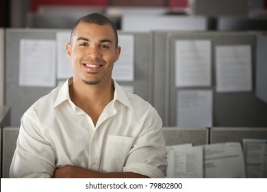 Confident Office Worker Smiles In His Office Cubicle