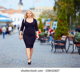 confident overweight woman walking the city street