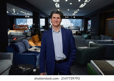 Confident Portrait Of A Successful Sales Manager, Retail Assistant, Furniture Store Owner, Director, Businessman Looking At Camera While Standing In The Expo Center Of Upholstered Furniture