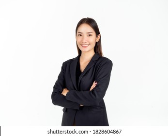 A Confident Pretty Young Asian Business Woman In Black Suit With Happy Smiling, Standing With Her Arms Folded And Looking At Camera Isolated On White Background.