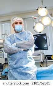 Confident Professional Doctor In Modern Hospital Room. Smiling Middle Aged Male Medical Professional Chief Physician.