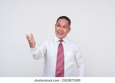 A confident professional gesturing with his hand. An animated middle aged asian man giving a lecture or presentation. In business attire, Isolated on a white background. - Powered by Shutterstock