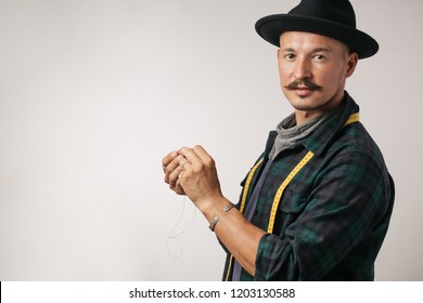 Confident professional shoemaker wearing moustache in trendy hat and handcraft tools isolated over white background - Powered by Shutterstock