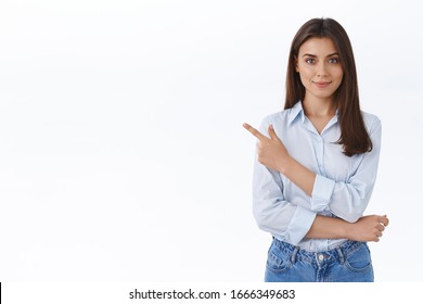 Confident Professional Young Woman In Blue Blouse Pointing Finger Upper Left Corner And Looking At Camera Persuade Customer Make Right Choice And Sign Deal With Her Company, White Background