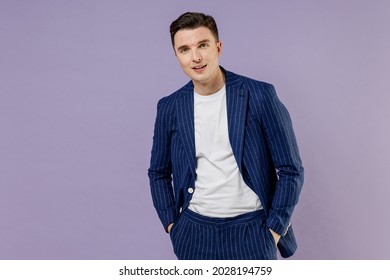 Confident Relaxed Young Successful Employee Business Man Lawyer 20s Wear Formal Blue Suit White T-shirt Work In Office Hold Hands In His Pockets Isolated On Pastel Purple Background Studio Portrait.