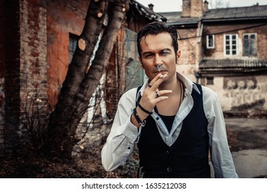 Confident Retro-styled Man Smoking Cigarette Ad Looking At Camera Outdoors. 