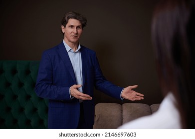 Confident Sales Rep, Retail Manager, Assistant In Upholstered Furniture Store Showroom Presents Orthopedic Mattresses To Female Customer, Helping Her To Make Purchase For Home Improvement