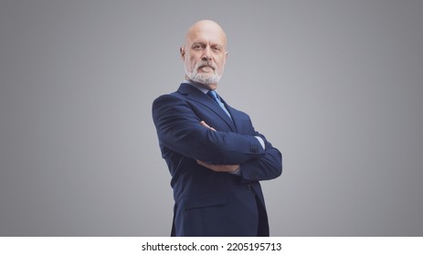 Confident senior businessman posing with arms crossed, leadership and determination concept, isolated on gray background - Shutterstock ID 2205195713