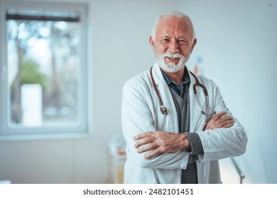 A confident senior Caucasian male doctor stands in a clinical setting, arms crossed, dressed in a white coat with a stethoscope, embodying professionalism and experience. - Powered by Shutterstock