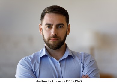 Confident Serious Millennial Business Man, Successful Company Leader, Founder, Professional Posing With Hands Folded, Looking At Camera. Businessman Indoor Head Shot Portrait