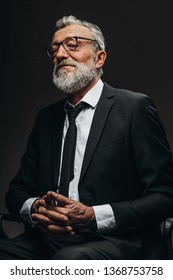 Confident Serious Senior Male Loyer In Round Spectacles And Formal Elegant Suit Looking At Camera With Wise Expression, Isolated Over White Background. Social Status And Age Concept