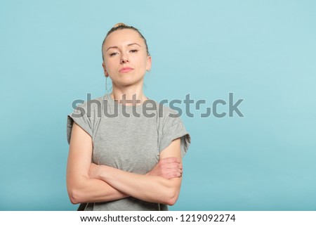 confident serious woman with crossed arms. look of defiance and self assurance.