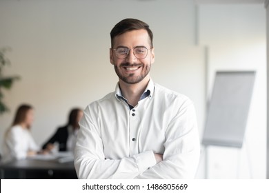 Confident smiling business man professional coach wear glasses stand arms crossed looking at camera, happy male executive company owner corporate manager leader in office, headshot close up portrait - Shutterstock ID 1486805669