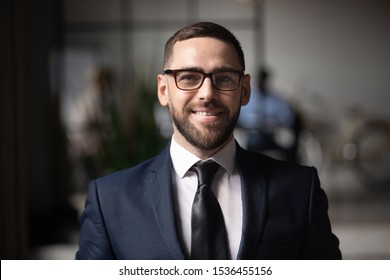 Confident Smiling Businessman Executive Wear Suit Glasses Looking At Camera, Happy Proud Professional Ceo Leader Male Company Owner Manager Posing In Office, Close Up Head Shot Business Portrait