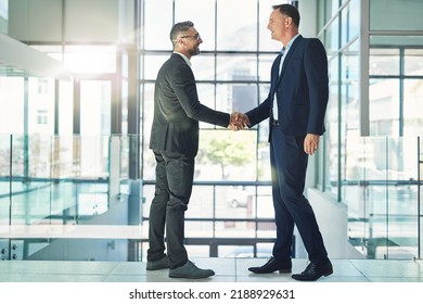Confident, smiling corporate businessmen exchange handshake in global trust merger meeting together at modern company. Professional executive colleagues in company trade development deal conference - Shutterstock ID 2188929631