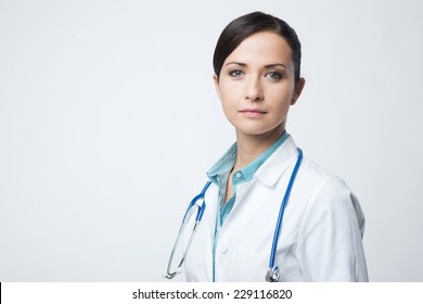 Confident Smiling Female Doctor Posing With Lab Coat And Stethoscope.