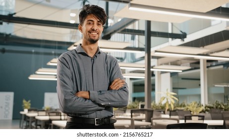 Confident Smiling Indian Business Man Male Financial Analyst Employee Professional Worker Stand In Office With Crossed Arms Arabian Handsome Adult Investor Posing Look At Camera Happy Face Expression