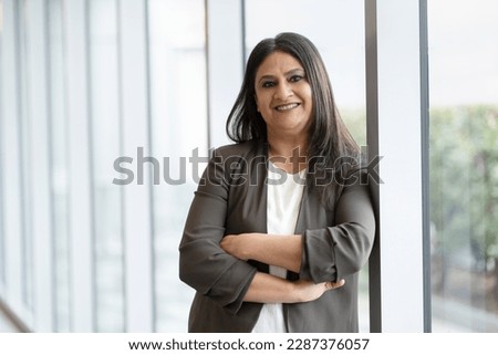 Similar – Image, Stock Photo Portrait of a middle-aged woman with sunglasses and dress on a stony beach of Lanzarote