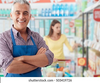 Confident smiling supermarket clerk posing at the shopping mall, retail job concept - Shutterstock ID 503419726