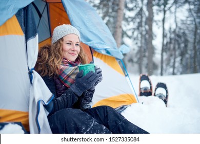 Confident Solo Woman Traveller Camping Through An Evergreen Winter Forest In Canada