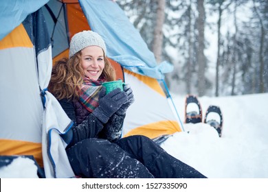 Confident Solo Woman Traveller Camping Through An Evergreen Winter Forest In Canada