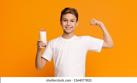 Confident Strong Teenager Enjoying Milk And Showing His Biceps, Orange Panorama Background