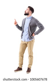 Confident Stylish Hipster Business Man Pointing Finger Up And Looking Above. Full Body Length Portrait Isolated On White Studio Background.