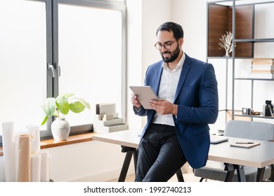 Confident Successful Arabian Businessman Tutor Freelancer CEO Working On Digital Tablet, Watching Webinars, E-learning, Checking E-mails Social Media, Reading News. Middle Eastern Financial Advisor