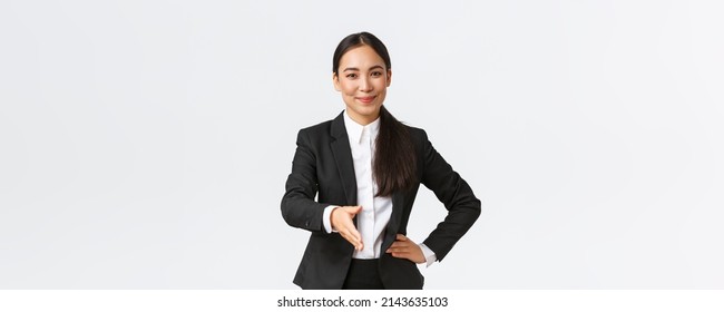 Confident Successful Businesswoman In Black Suit Extend Hand For Handshake, Greeting Business Partner With Pleased Determined Smile, Ready Sign Contract, White Background