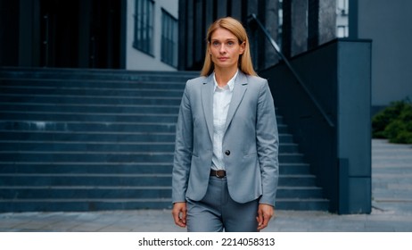 Confident Successful Caucasian Businesswoman In Formal Suit Walking On Street Against Backdrop Office Building Serious Proud Woman Professional Manager Agent Adviser Leader Walks Outdoors Walk Alone