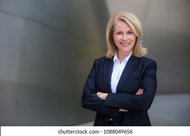 Confident and successful CEO business woman in a suit with arms folded
