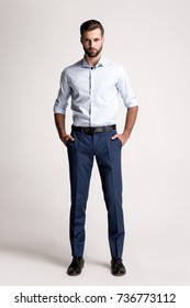 Confident And Successful. Full Length Of Handsome Young Man Looking At Camera While Standing Against White Background.