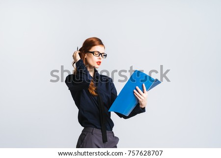 confident successful girl in glasses and in dark clothes reading documents