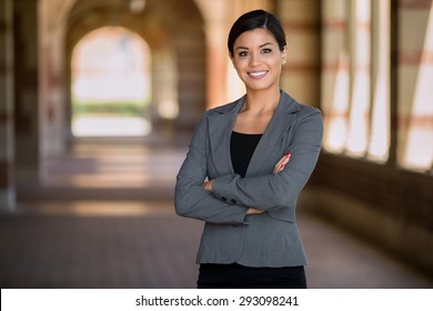 Confident successful smiling business woman executive with folded arms 