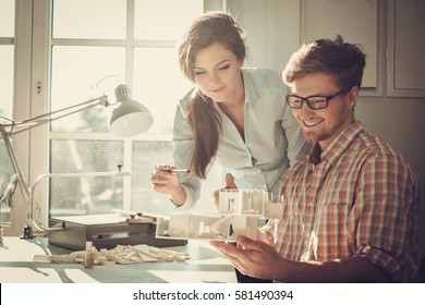 Confident team of engineers working together in a architect studio - Powered by Shutterstock