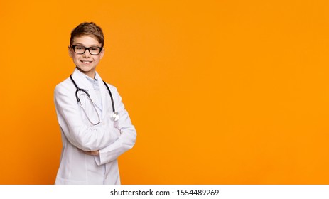 Confident teen doctor with stethoscope posing with arms crossed, orange panorama background with empty space