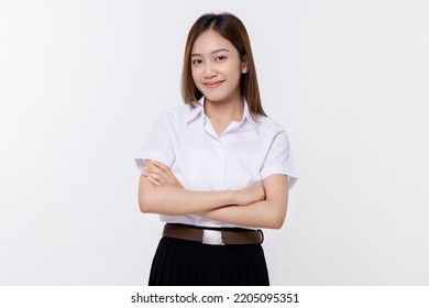 Confident Teen Student Girl Of Asian Ethnicity In University Uniform Crossing Arms Isolated Over White Background.