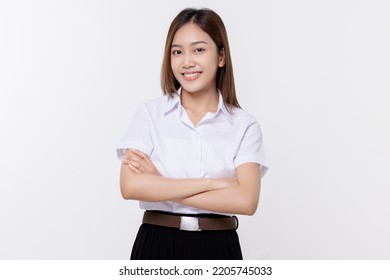 Confident Teen Student Girl Of Asian Ethnicity In University Uniform Crossing Arms Isolated Over White Background.
