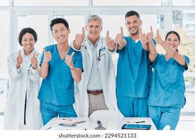 As confident as they are capable. Portrait of a group of medical practitioners showing thumbs up together in a medical office. - Powered by Shutterstock