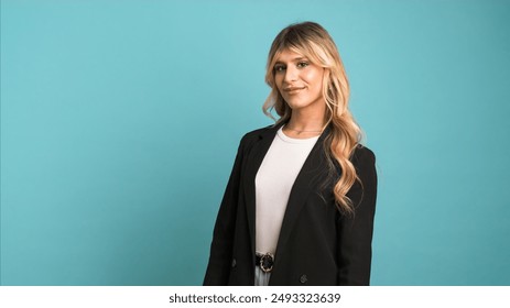 Confident transgender businesswoman smiling and looking at camera on blue background - Powered by Shutterstock