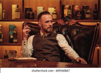 Confident Upper Class Man Smoking Cigar In Gentlemen's Club