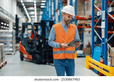 Confident warehouse manager supervising loading with tablet for efficient logistics. Modern tech ensures seamless control of goods distribution. Safety is top priority in busy industrial setting - Powered by Shutterstock