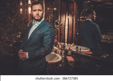 Confident Well-dressed Man In Luxury Bathroom Interior.