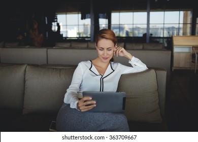 Confident Woman Ceo Reading Information On Portable Touch Pad While Waiting For Start Meeting With Business Partner,young Female Watching News Via Network On Digital Tablet While Sitting In Restaurant