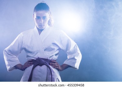 Confident Woman Wearing Karate Kimono with Her Hands on Her Hips - Powered by Shutterstock