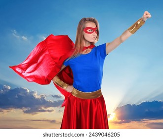 Confident woman wearing superhero costume against cloudy sky - Powered by Shutterstock