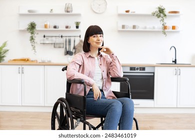 Confident woman in wheelchair enjoying time in bright kitchen. Home environment with modern decor and positive vibes. - Powered by Shutterstock