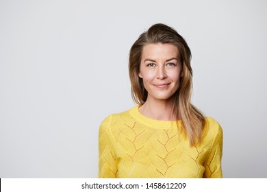 Confident woman in yellow top, portrait