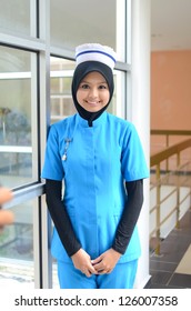 Confident Young Asian Muslim Nurse At Hospital