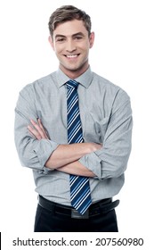 Confident young business executive with crossed arms 